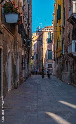 VENICE, ITALY - August 27, 2021: People walking by over Venice streets during the pandemic