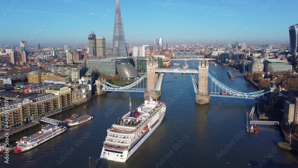Aerial view of the skyline of London with Tower Bridge lift and a cruise ship passing by on the Thames river