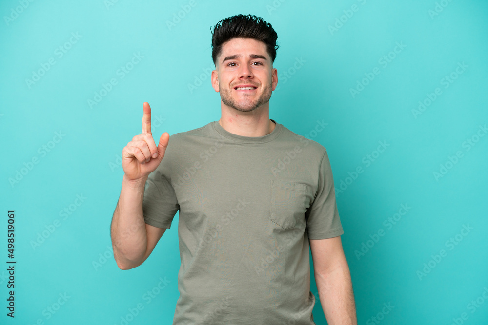 Young caucasian man isolated on blue background pointing up a great idea Young caucasian man isolated on blue background pointing up a great idea