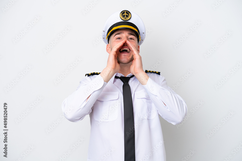 Airplane caucasian pilot isolated on white background shouting and announcing something Airplane caucasian pilot isolated on white background shouting and announcing something