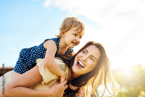 Having a ball of a time outdoors. Shot of a mother bonding with her adorable little daughter outdoors.