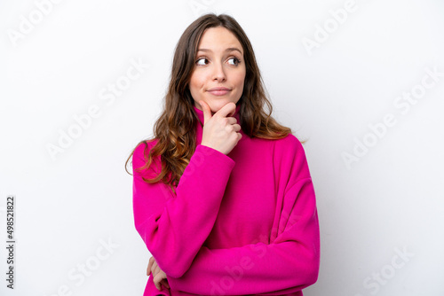 Young caucasian woman isolated on white background thinking an idea while looking up