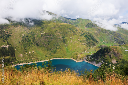 Savoie, France. Gittaz lake. Clouds over the mountains. photo