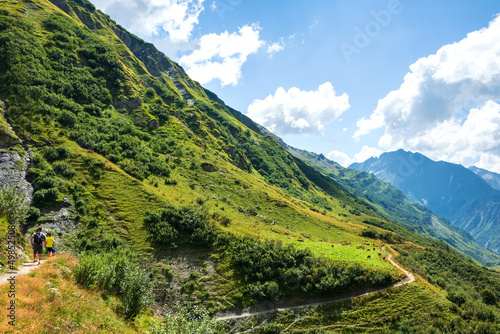 Family hiking in French Alps mountains in summer. Chapieux valley, Savoie, France. Healthy active sportive lifestyle concept. Family leisure together background. © Elena Dijour