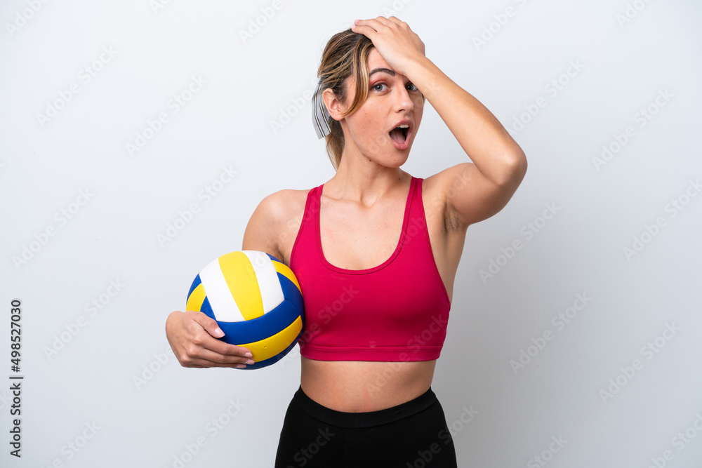 Young caucasian woman playing volleyball isolated on white background doing surprise gesture while looking to the side Young caucasian woman playing volleyball isolated on white background doing surprise gesture while looking to the side