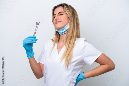 Dentist woman holding tools isolated on white background suffering from backache for having made an effort