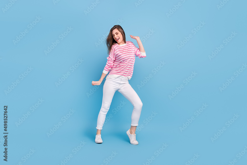 Full length portrait of satisfied glad nice lady have fun discotheque partying isolated on blue color background Full length portrait of satisfied glad nice lady have fun discotheque partying isolated on blue color background