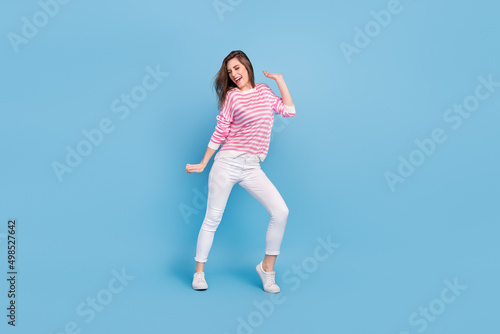 Full length portrait of satisfied glad nice lady have fun discotheque partying isolated on blue color background