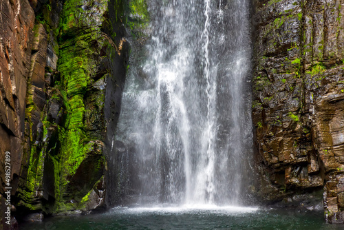 Gorgeous and paradisiacal waterfall of V    u da Noiva  Veil of the Bride  among the mossy rocks and vegetation located in Serra do Cipo in the state of Minas Gerais  Brazil and