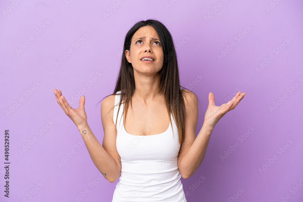 Young caucasian woman isolated on purple background stressed overwhelmed