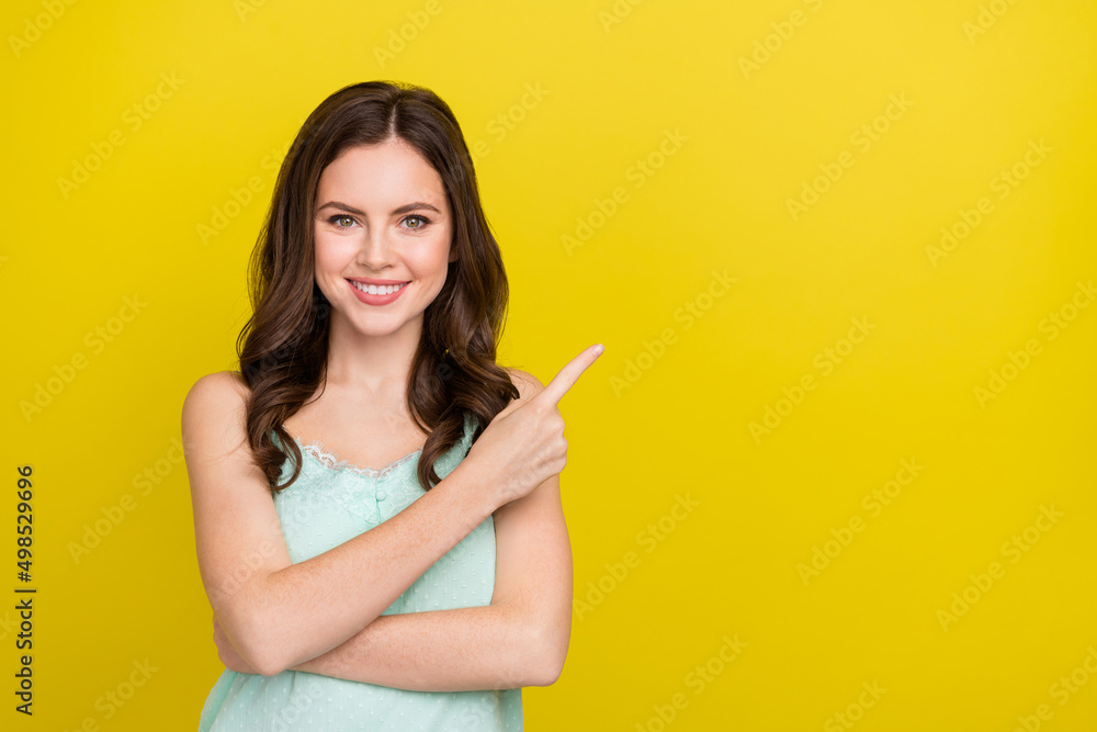 Photo of adorable good mood positive female recommend ad product object isolated on yellow color background Photo of adorable good mood positive female recommend ad product object isolated on yellow color background