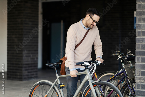 An environmentally conscious man taking bicycle to ride.