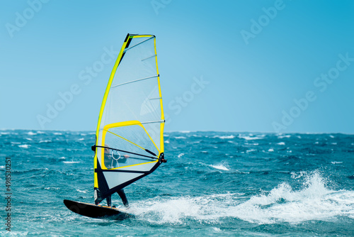 windsurf riding the waves during a windy summer day © Michele Morrone
