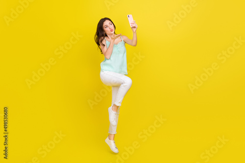 Full body photo of cute flirty coquettish female make lovely video for her boyfriend isolated on yellow color background