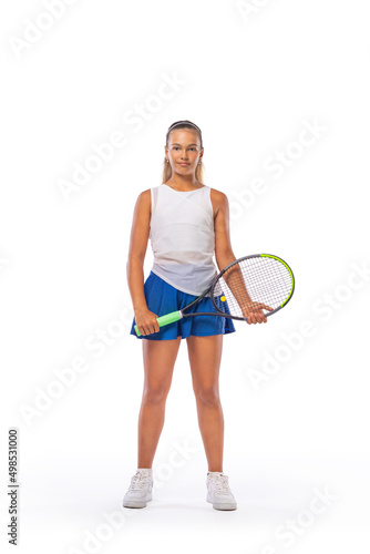 Tennis player on the blue background. Beautiful girl teenager and athlete with racket in white sporswear and hat on tennis court. Fashion and sport concept.