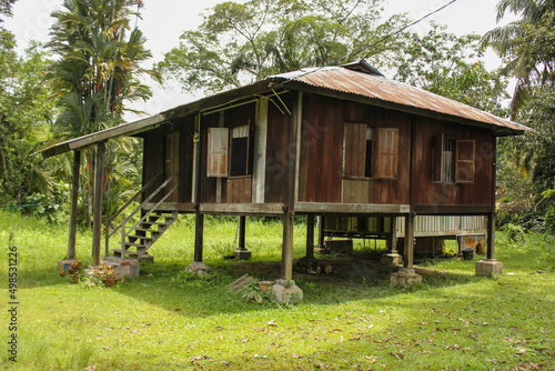 A small rustic wooden shack with a green garden in the heritage town of Ipoh. © Balaji