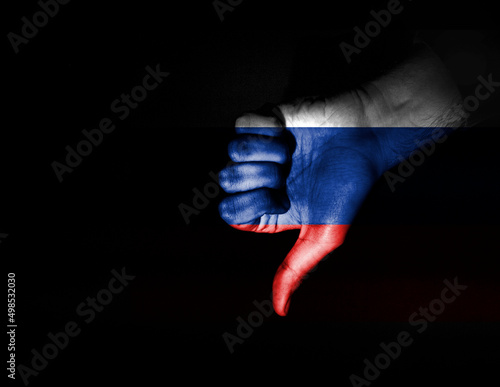 hand making dislike sign painted in the colors of the russian flag