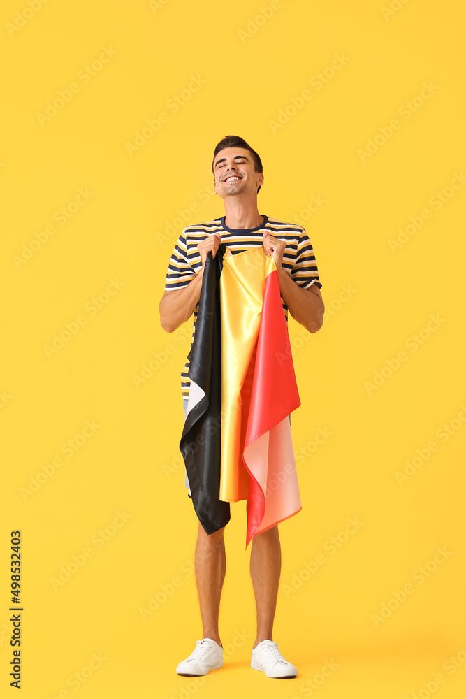 Young man with flag of Belgium on color background Young man with flag of Belgium on color background