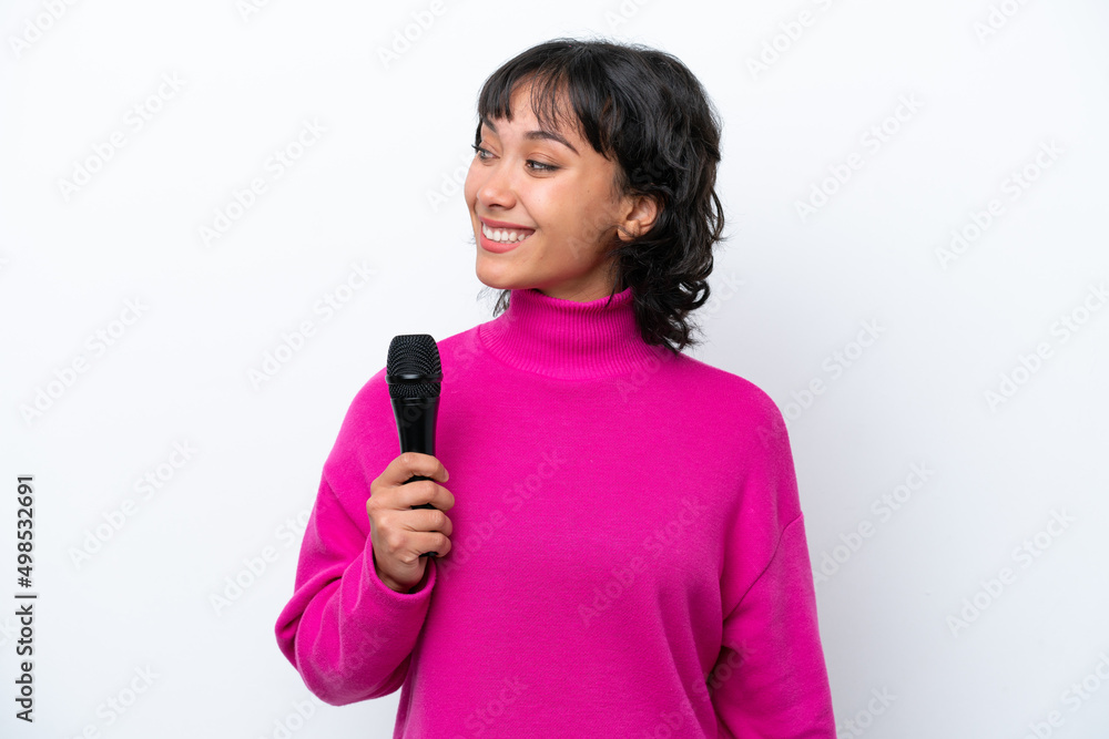 Young Argentinian singer woman isolated on white background looking to the side and smiling Young Argentinian singer woman isolated on white background looking to the side and smiling