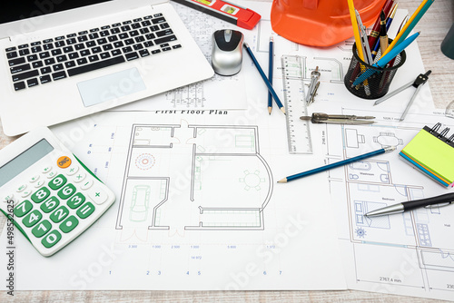 house project plan with work tools and helmet on desk