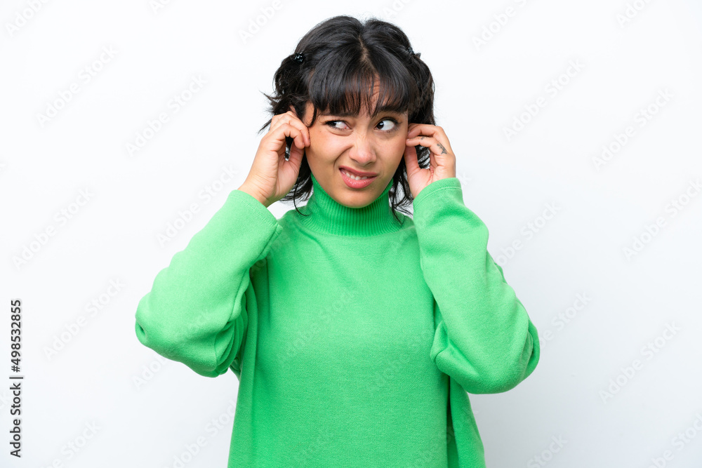 Young Argentinian woman isolated on white background frustrated and covering ears Young Argentinian woman isolated on white background frustrated and covering ears