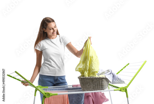 Young woman hanging laundry...