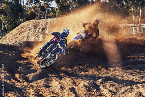 Time to rip up this track. Shot of a motocross rider chasing down the competitor in first place.