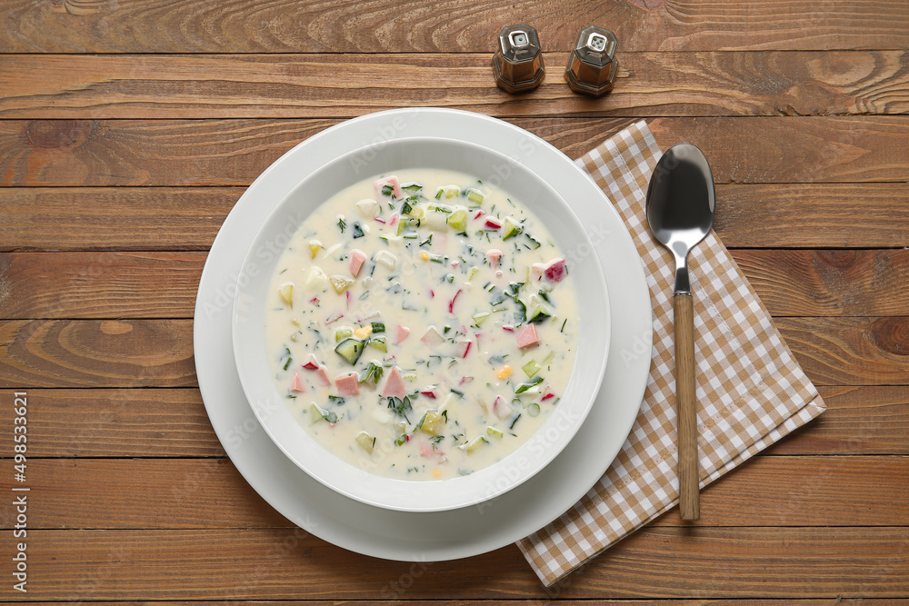 Plate with tasty okroshka on wooden background Plate with tasty okroshka on wooden background