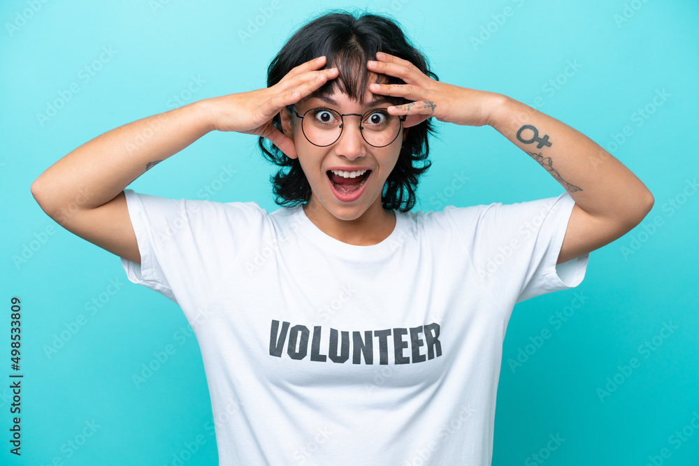 Fototapeta premium Young volunteer Argentinian woman isolated on blue background with surprise expression