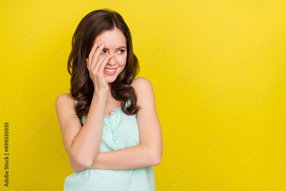 Photo of beautiful adorable stunning lady look empty space have fun laughing isolated on yellow color background Photo of beautiful adorable stunning lady look empty space have fun laughing isolated on yellow color background