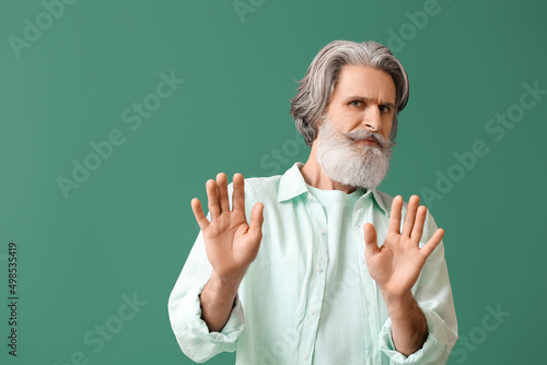 Upset senior man in shirt o...