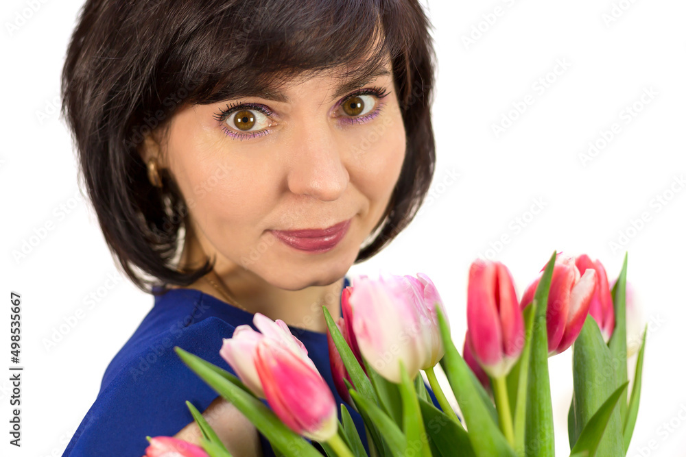 Portrait of a brunette woman with a bouquet of beautiful bright pink tulips on a white background. Portrait of a brunette woman with a bouquet of beautiful bright pink tulips on a white background.