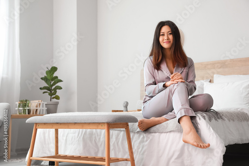 Young Asian barefoot woman ...