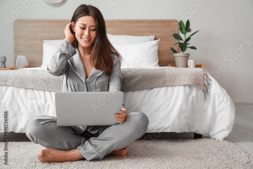 Young Asian barefoot woman ...