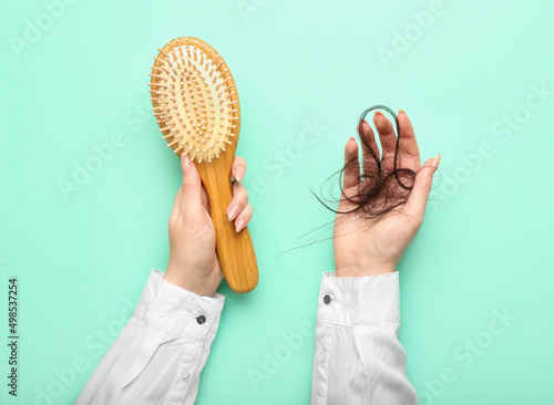 Canvas Print Woman with brush and clump of hair on blue background