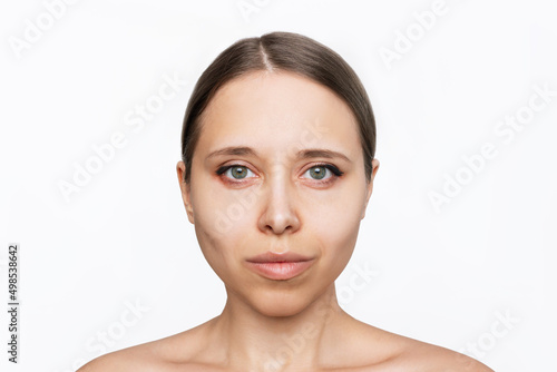 Portrait of a young attractive caucasian woman with makeup isolated on a white background. A model with even proportional facial features. Natural beauty and fashion. Skin care. Close-up