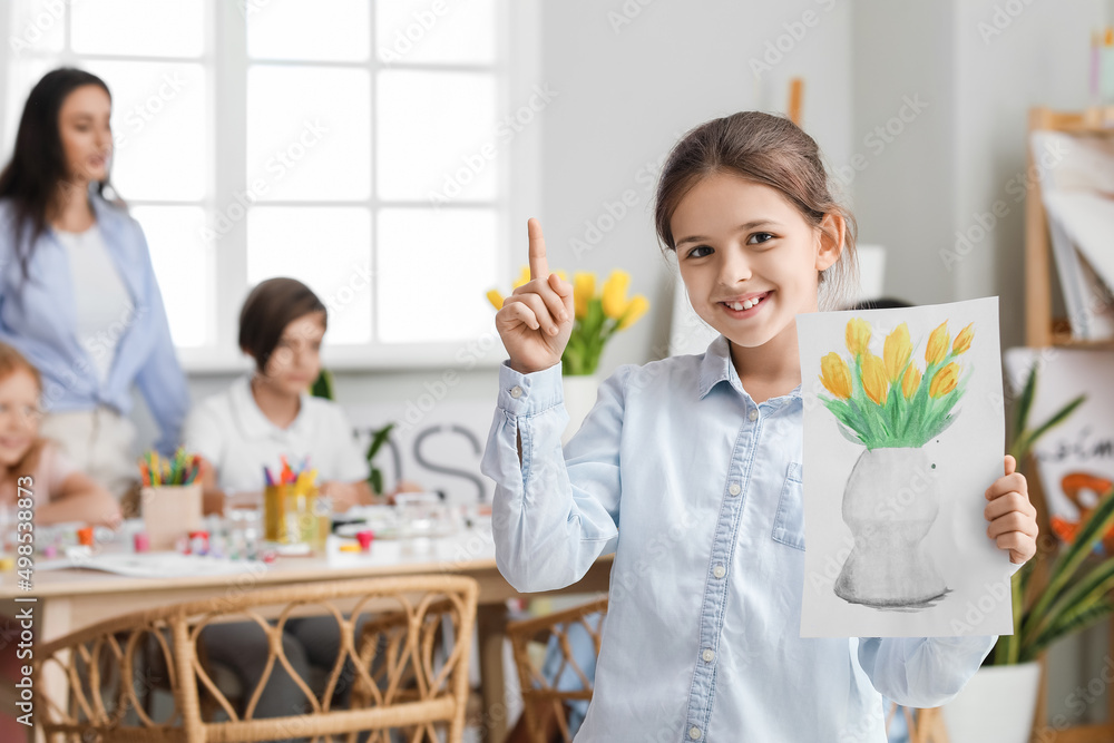 Cute girl with picture painted during master-class in art Cute girl with picture painted during master-class in art