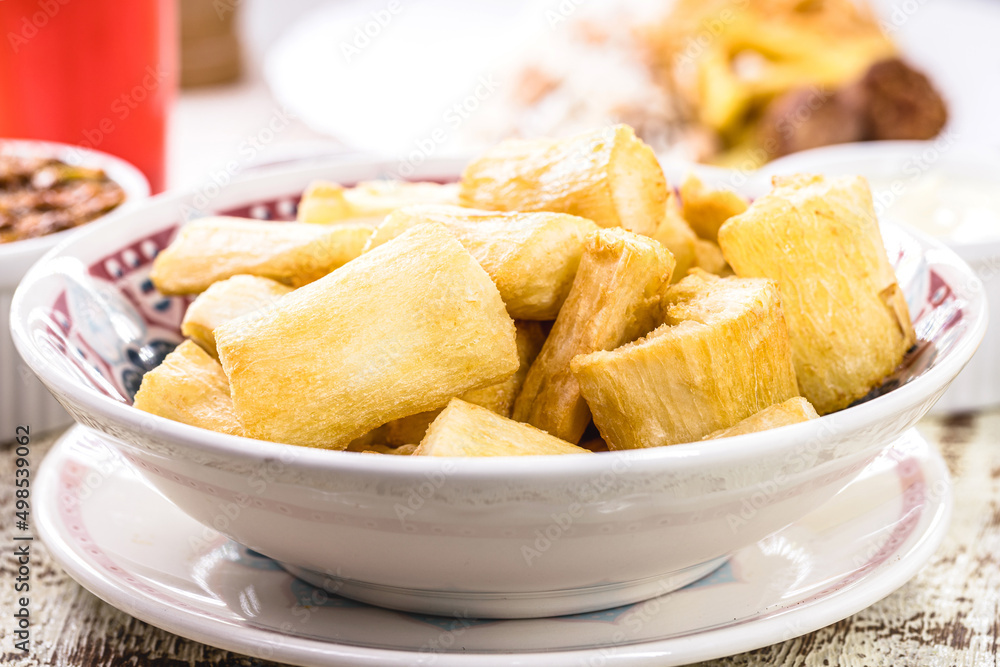 fried cassava with vegetables and sauces, a typical Brazilian snack served in restaurants and bars fried cassava with vegetables and sauces, a typical Brazilian snack served in restaurants and bars