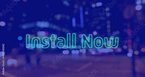 Image of install now text over cityscape at night on blue background