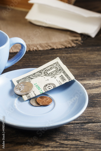 Slika na platnu Restaurant tips or gratuity, american banknotes and coins on plate