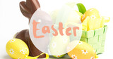 Image of easter text over chocolate rabbit and easter eggs