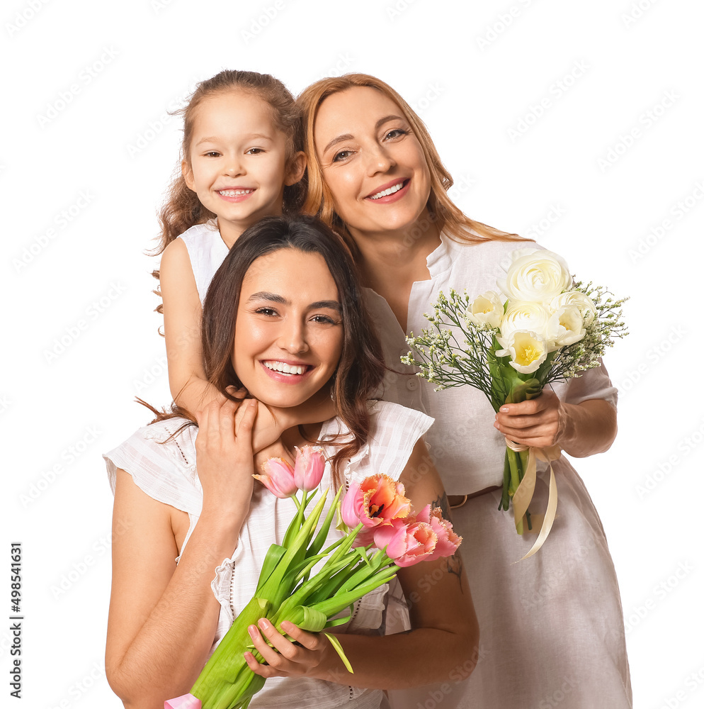 Young woman, her little daughter and mother with flowers on white background. International Women's Day celebration Young woman, her little daughter and mother with flowers on white background. International Women's Day celebration
