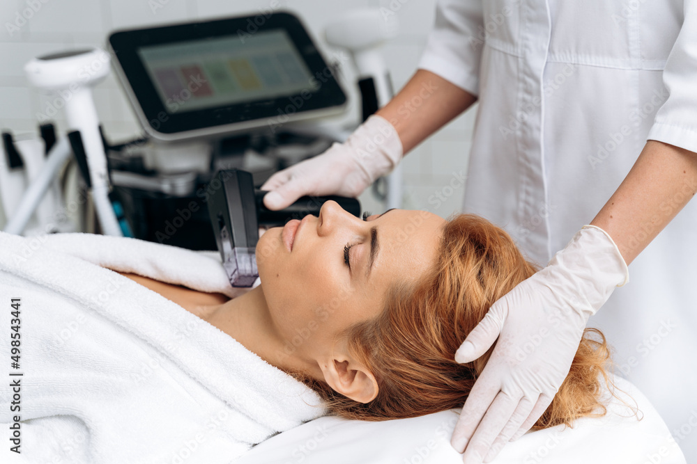 Woman laying at the couch with closed eyes in professional beauty clinic Woman laying at the couch with closed eyes in professional beauty clinic