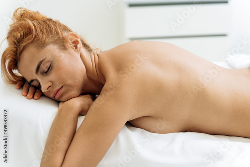 Relaxed young woman is waiting for skin care treatment at beauty cosmetology spa salon
