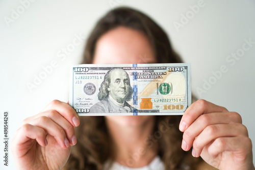 The girl holds American dollars.