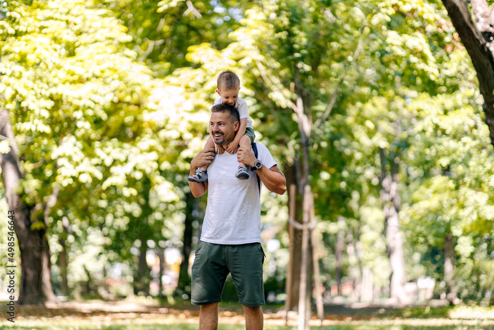 Father and little boy having piggyback ride on pure air in nature. Father and little boy having piggyback ride on pure air in nature.