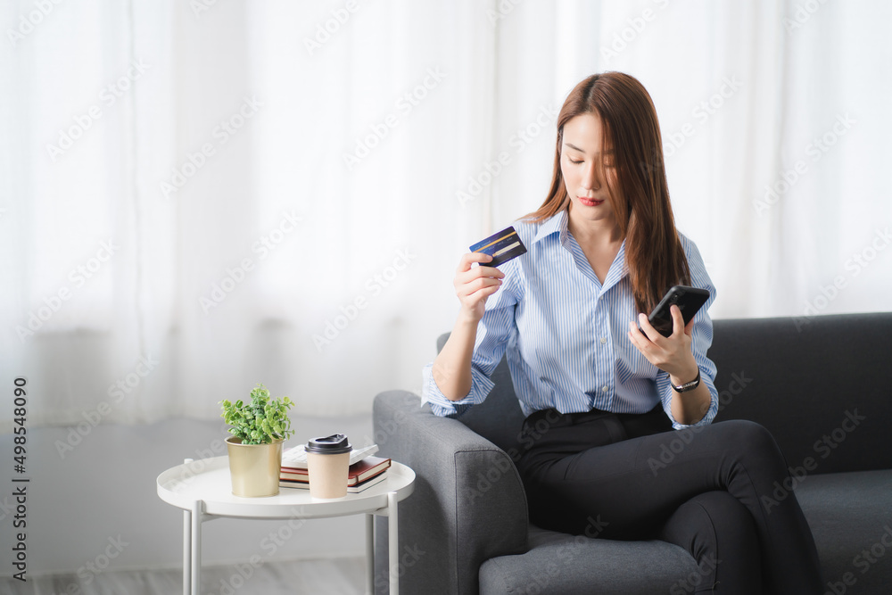 Portraits of beautiful smiling Asian women relax using laptop computer technology while sitting on their desks and using their creativity to work, work from home concept.