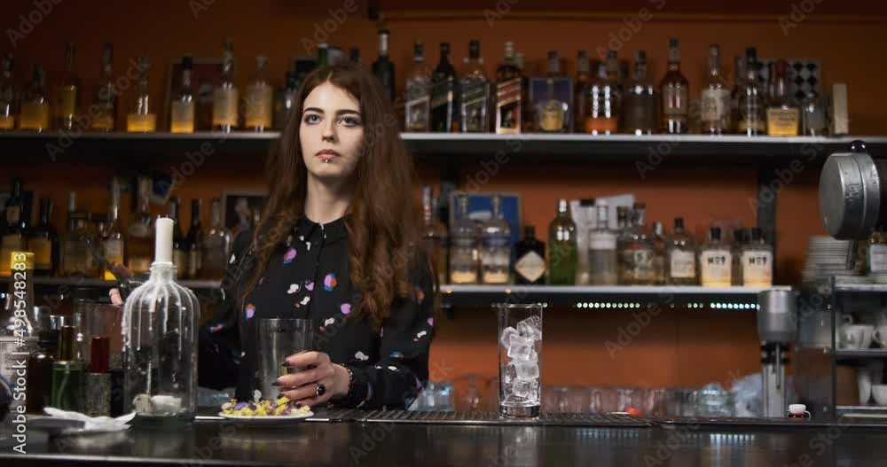 Redhead girl Young adult woman bartender prepares mixes bloody mery cocktail at the bar Redhead girl Young adult woman bartender prepares mixes bloody mery cocktail at the bar