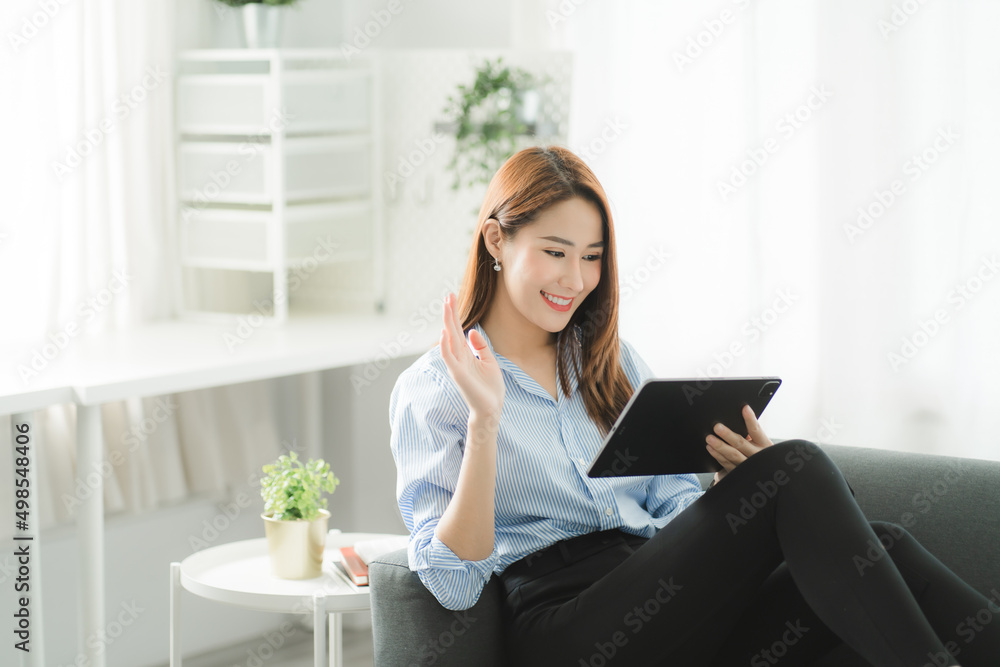 Portraits of beautiful smiling Asian women relax using laptop computer technology while sitting on their desks and using their creativity to work, work from home concept. Portraits of beautiful smiling Asian women relax using laptop computer technology while sitting on their desks and using their creativity to work, work from home concept.