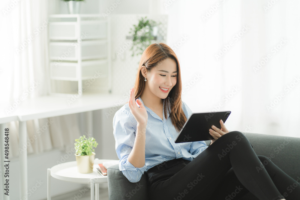 Portraits of beautiful smiling Asian women relax using laptop computer technology while sitting on their desks and using their creativity to work, work from home concept. Portraits of beautiful smiling Asian women relax using laptop computer technology while sitting on their desks and using their creativity to work, work from home concept.